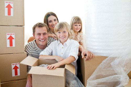 Movers handling office desks and boxes during a South London business relocation